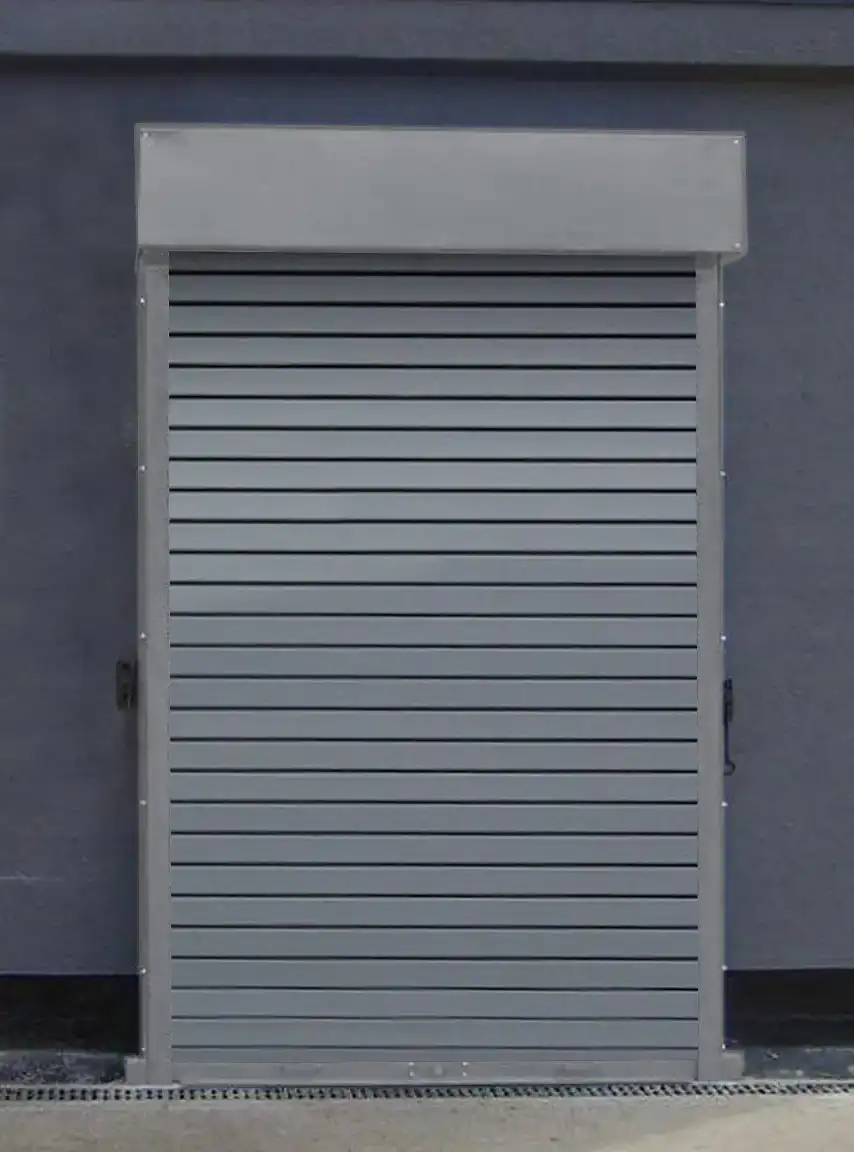 Push up manually operated Ganymede insulated roller shutter door protecting an entrance door in grey