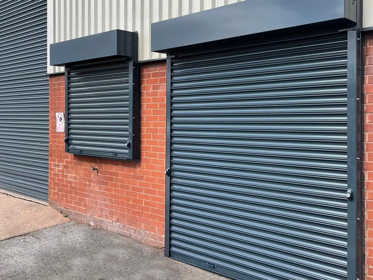 Push up and geared chain manually operated roller shutter doors on a window and entrance door opening