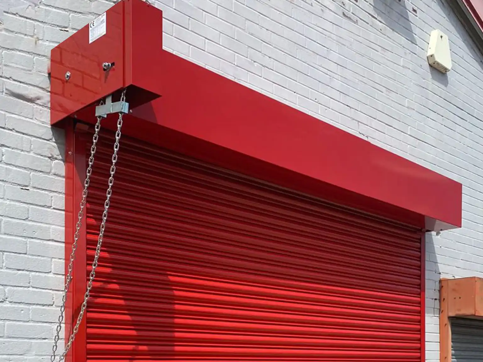Detail of geared chain manually operated roller shutter door on a warehouse entrance