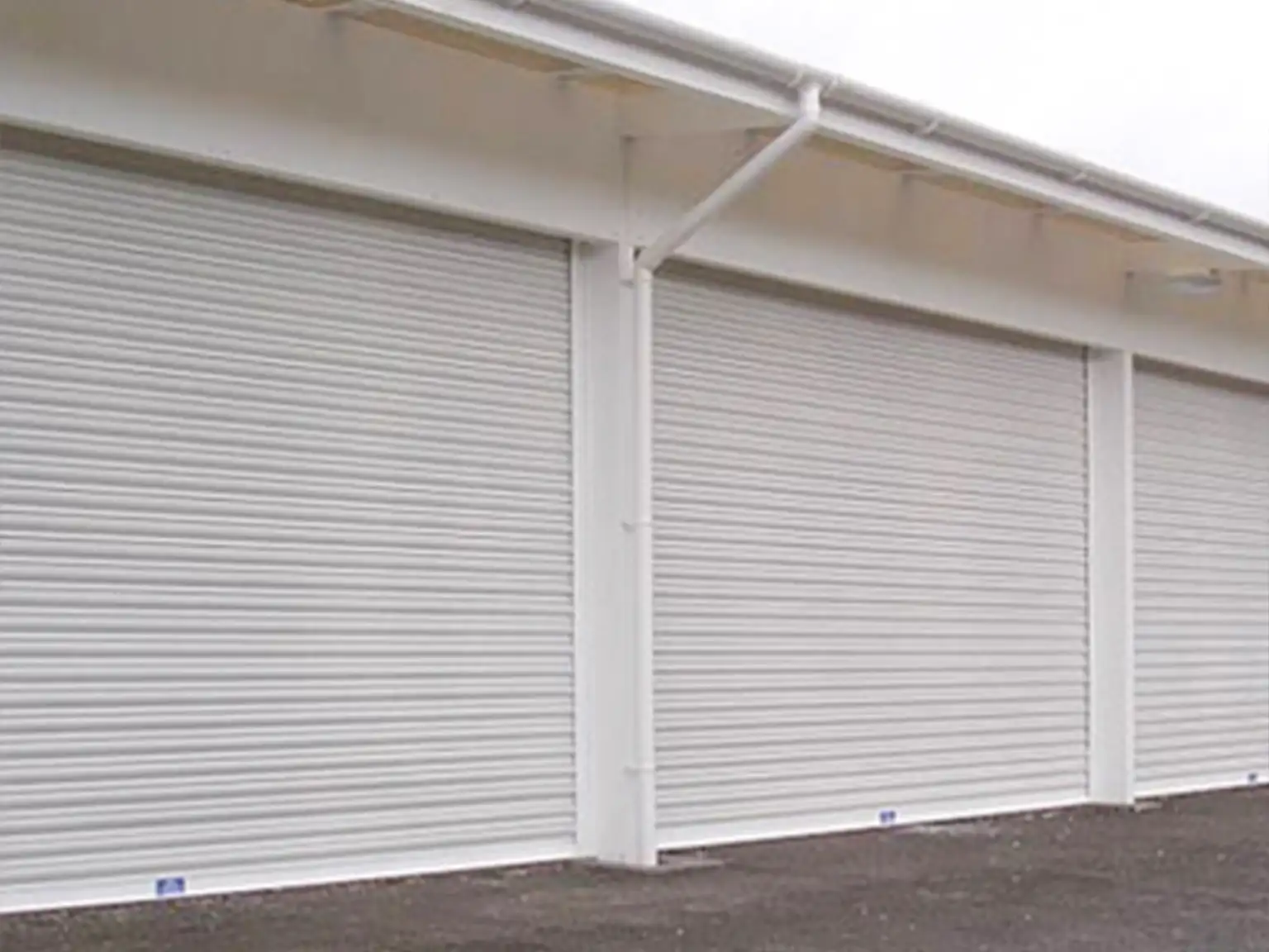 Run of industrial roller shutter doors operated manually via a hand chains