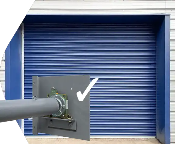 Blue Priory roller shutter door on a steel building with detail of tested security break
